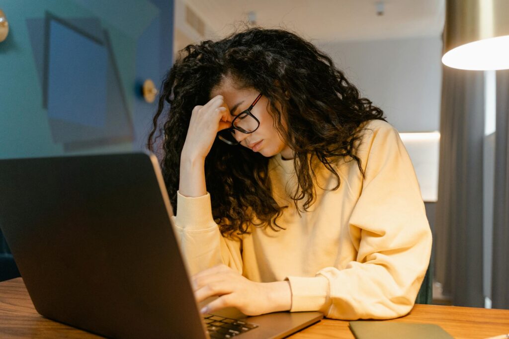 overwhelmed new eBay reseller working on laptop