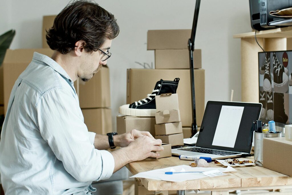 ebay reseller business workspace with packages and laptop
