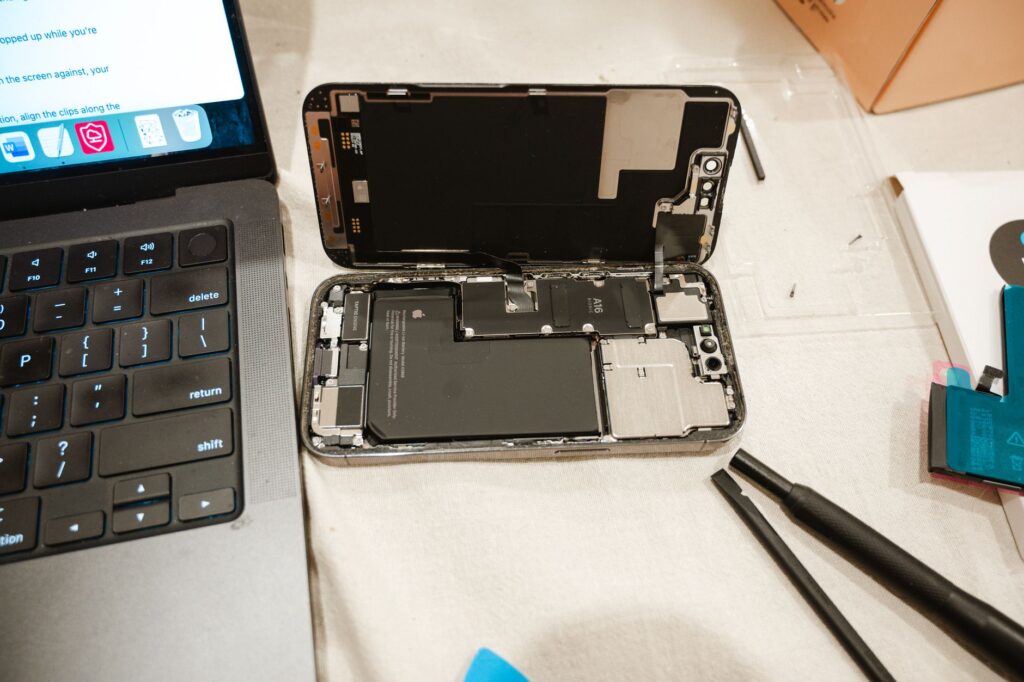 diy iphone repair with tools and laptop