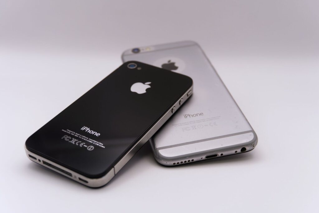 close up of two smartphones on white background